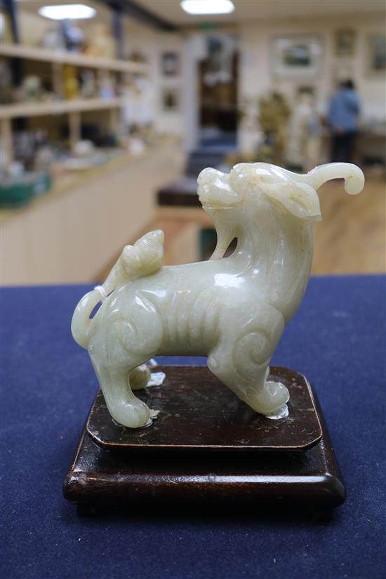 Two Chinese celadon jade figures of a fisherman and a lion-dog, 6.2 and 11cm, wood stands